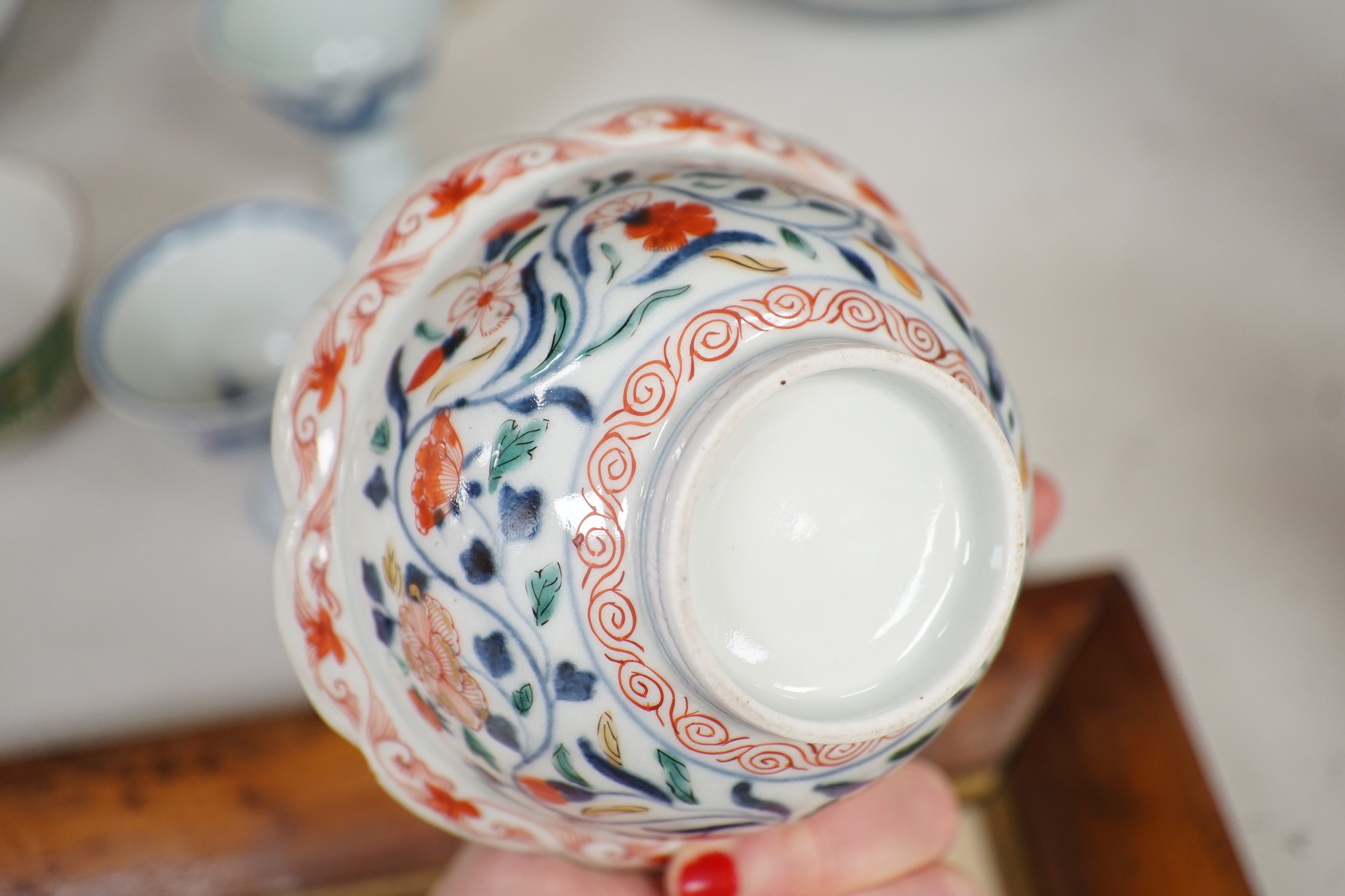 A Chinese wucai vase, two Imari bowls, a pair of Chinese blue and white dragon stem cups, Xuande marks, a Chinese blue and white dish, depicting a scholar on horseback, Xuande mark, a small green Chinese bowl, painted wi